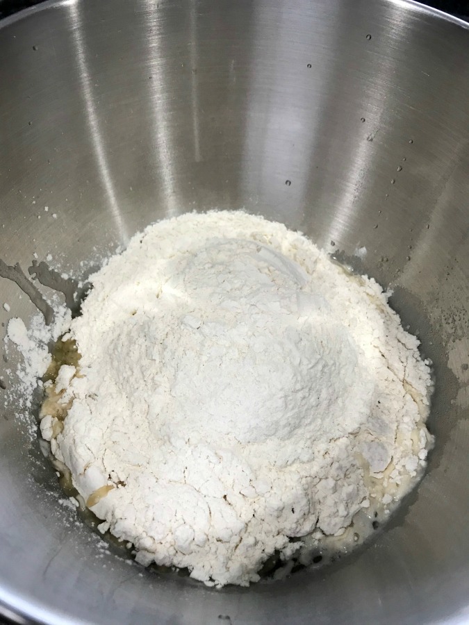 Bread flour in a silver mixing bowl