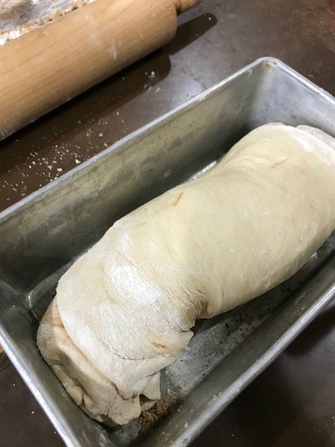 Uncooked cinnamon bread dough in a loaf pan