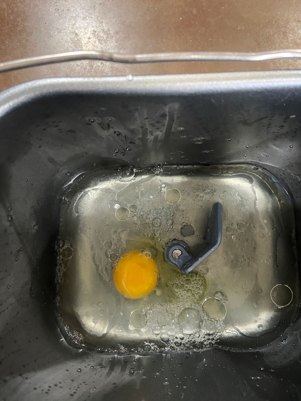 water and egg in a bread machine pan. 