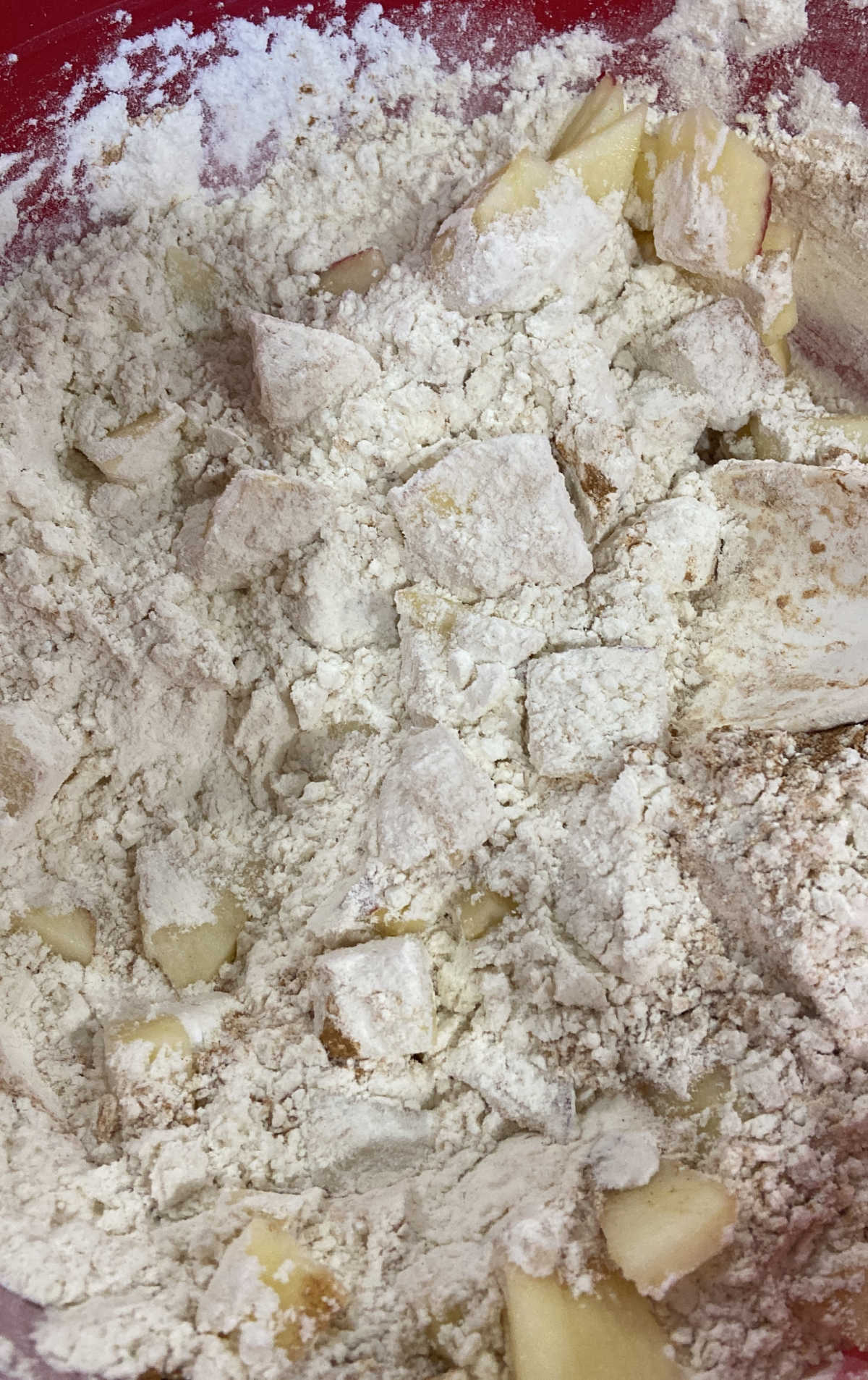 apples mixed into a dry flour mixture.