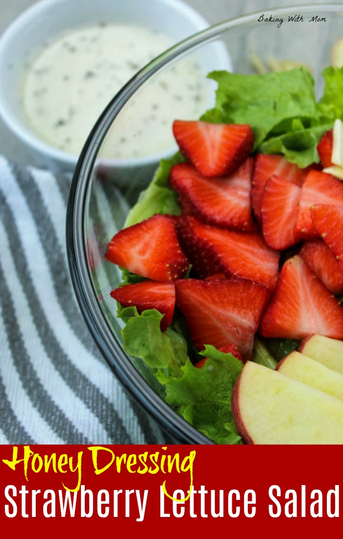 Strawberry Lettuce Salad with strawberries on top in a clear bowl