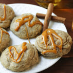 caramel cookies on a white plate with cinnamon sticks.