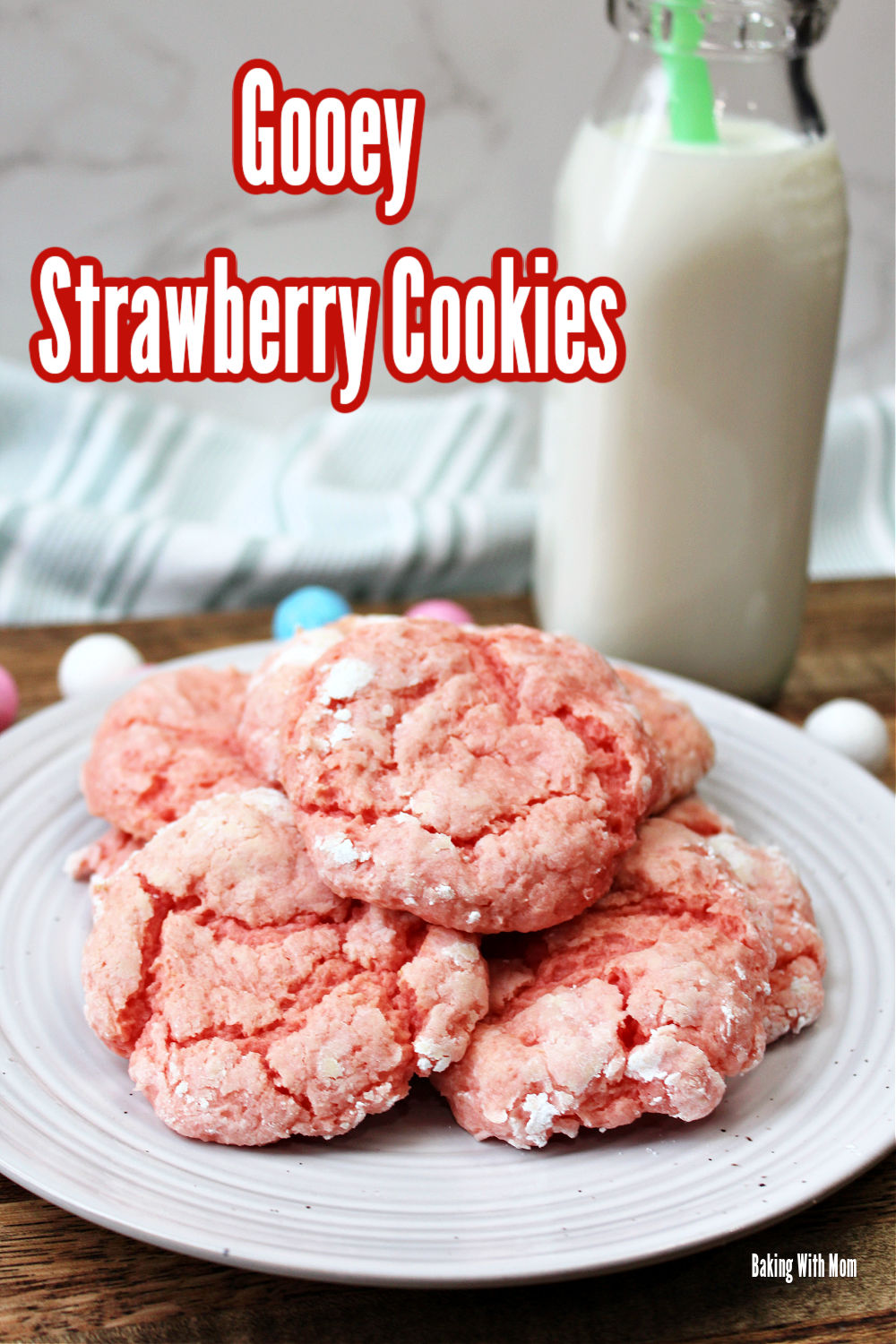 Gooey strawberry cookies on a white plate with milk behind. 