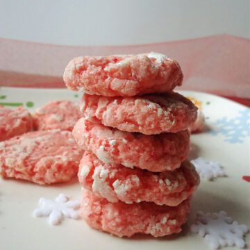 strawberry cookies stacked on a white plate