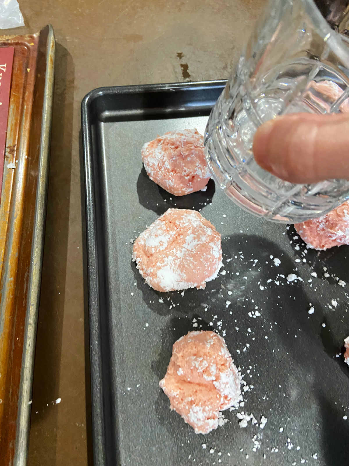 glass flattening a cookie. 