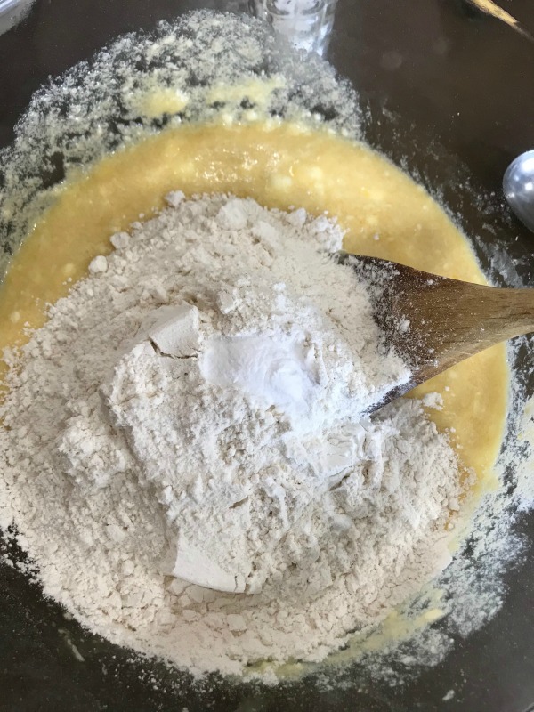 Flour and salt mixed in a butter sugar batter in a clear bowl