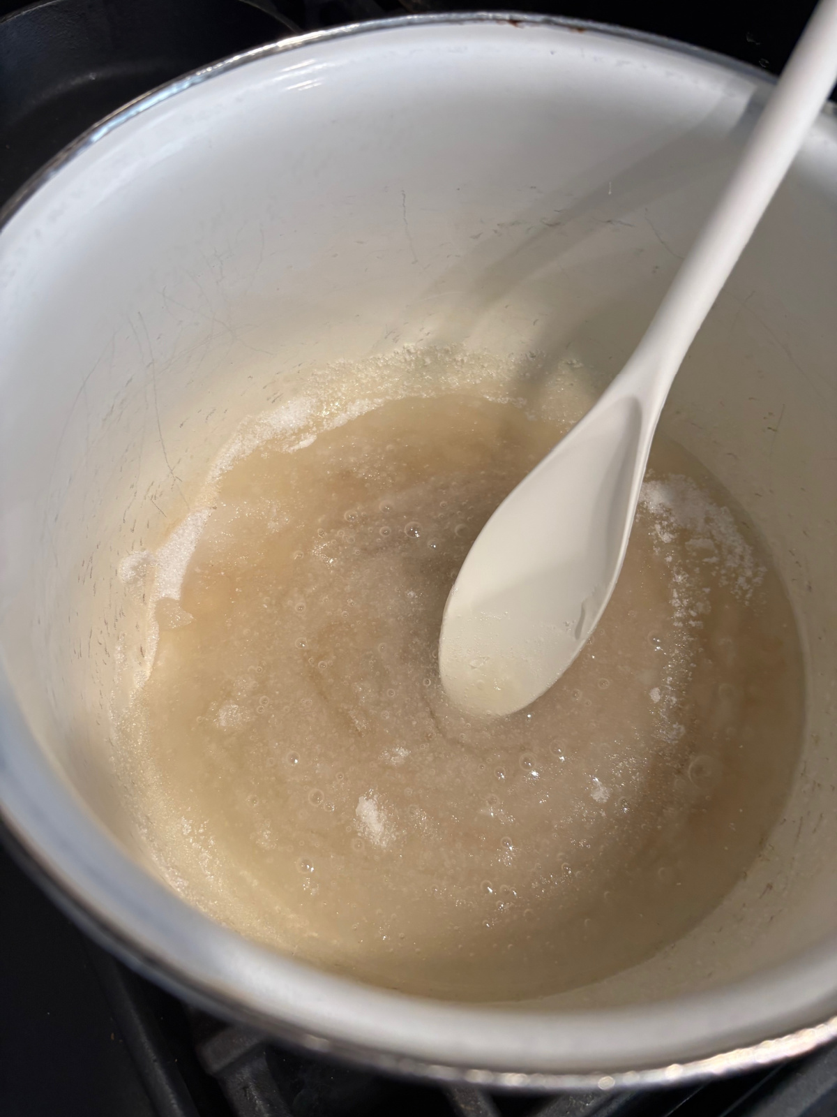 corn syrup and sugar in a white pot. 
