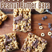 peanut butter bars on a brown tray with Cheerios and chocolate chips besides.
