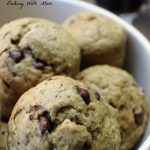 Mocha Muffins with chocolate chips in a cream colored bowl with coffee cup