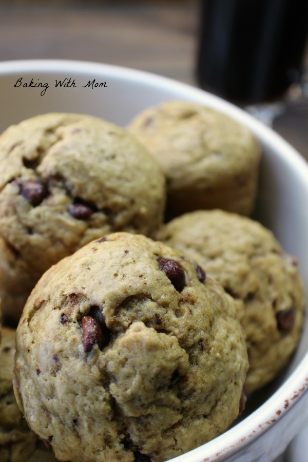 Mocha Muffins with chocolate chips in a cream colored bowl with coffee cup 