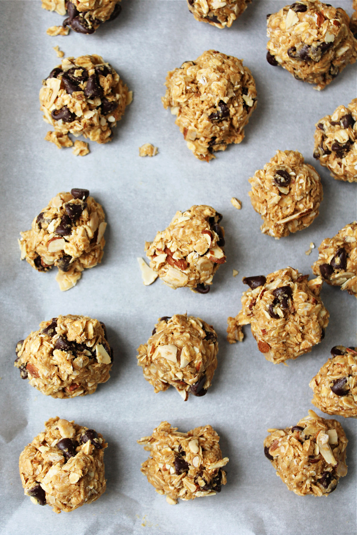 energy bites on a parchment paper in a baking sheet. 