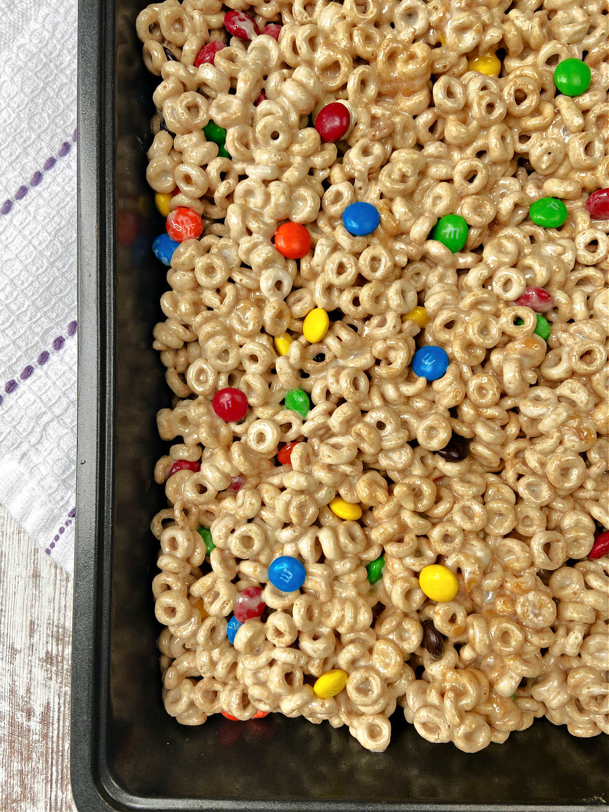 caramel cheerios bars in a baking pan. 