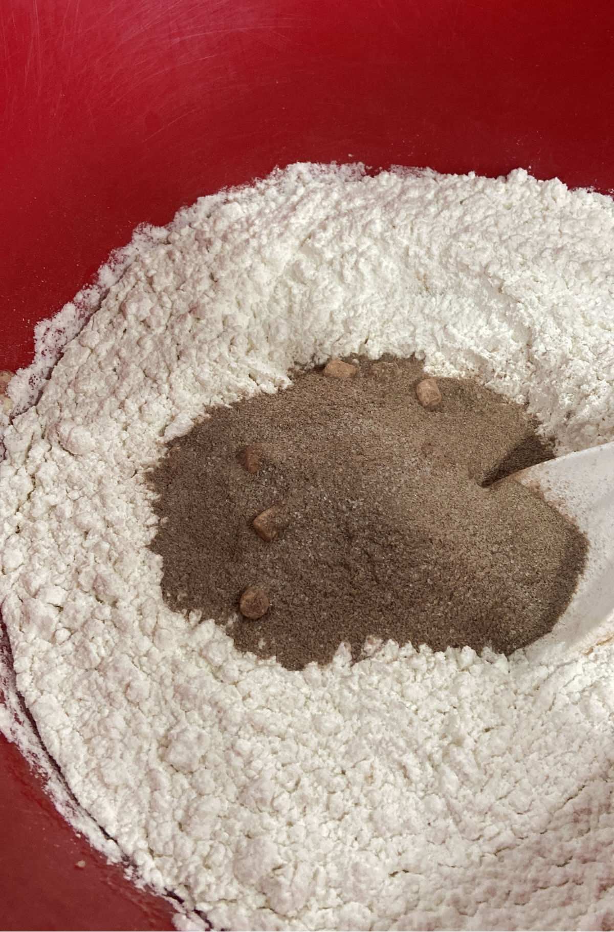 hot chocolate mix in a red bowl with flour. 