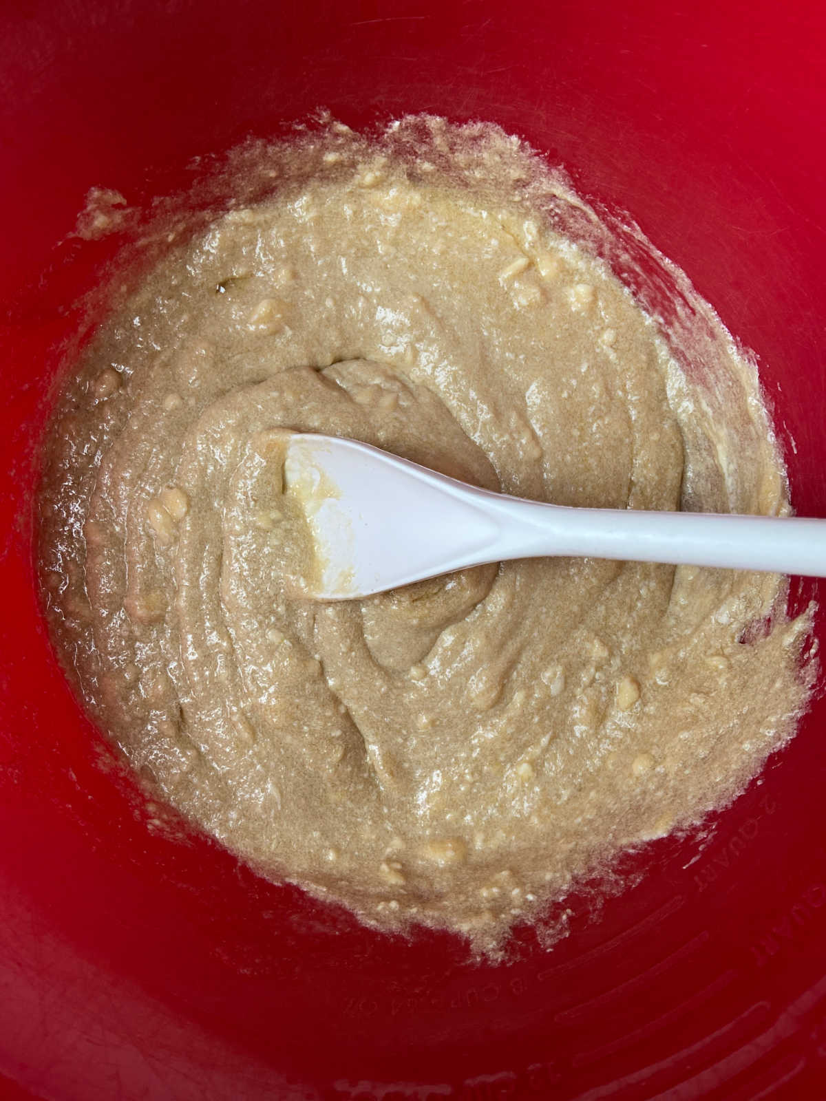 cookie batter in a red bowl.