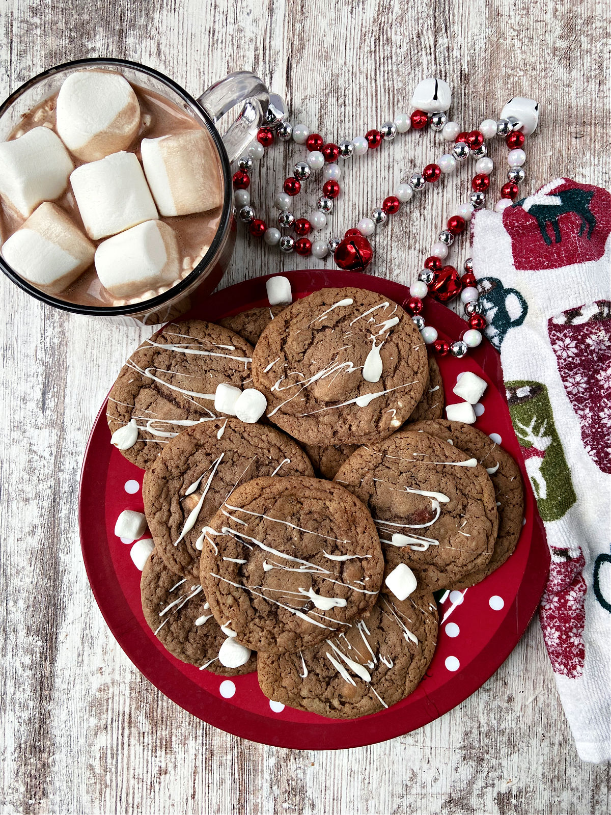 hot chocolate cookies on a red plate with marshmallows. 