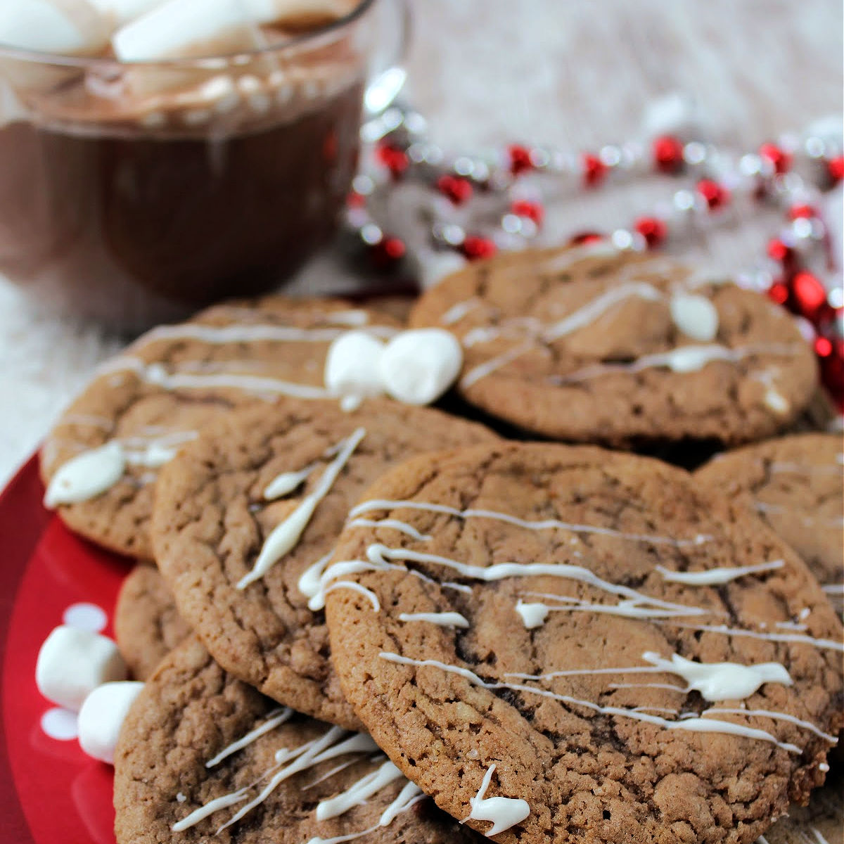 chocolate cookies on a red plate with marshmallows.