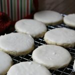 White Velvet Cookies with cream cheese and creamy white frosting on top of a baking sheet