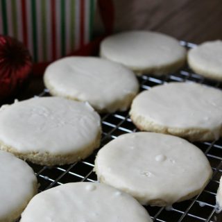 White Velvet Cookies with cream cheese and creamy white frosting on top of a baking sheet