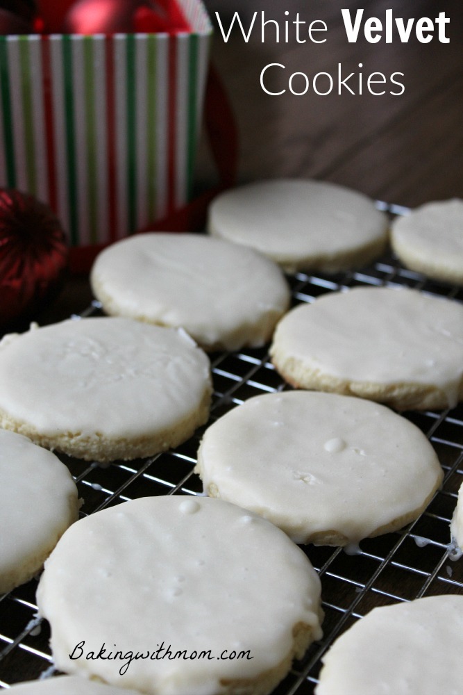 White Velvet Cookies with cream cheese and creamy white frosting on a cooling rack.
