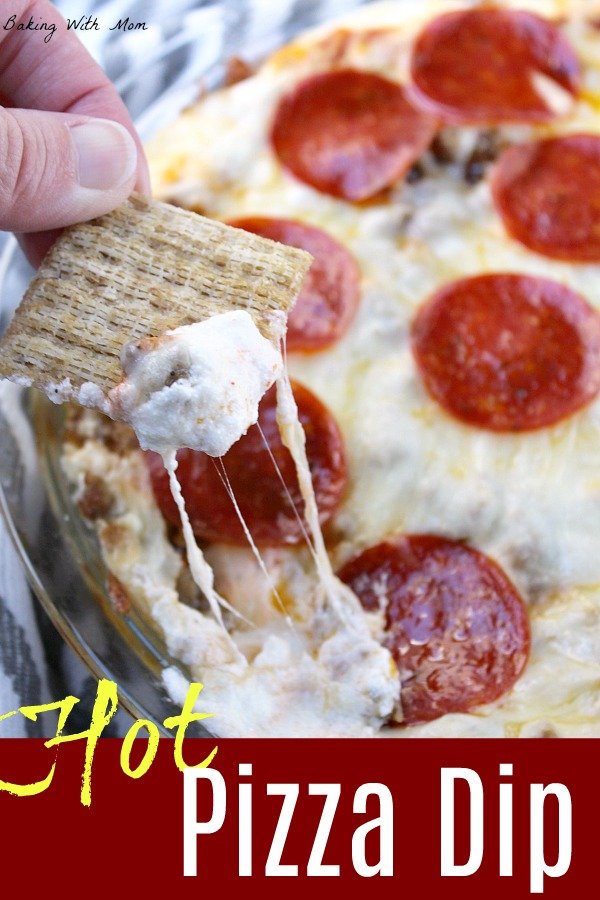 Hot pizza dip in a pie pan with cheese and crackers