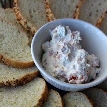tomato dip in a white bowl with bread