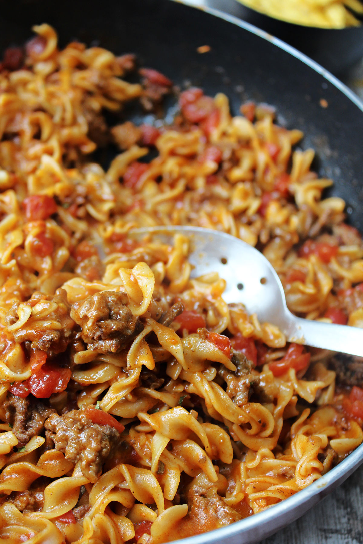 taco goulash in a pan with a spoon. 