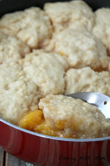 Peach dumplings in a red skillet.