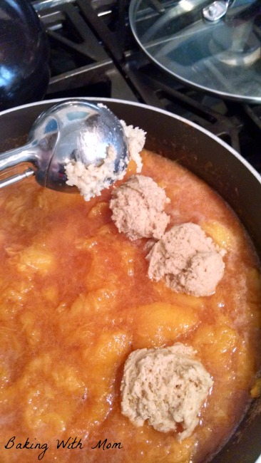 Peach dumpling dough being added on top of peaches