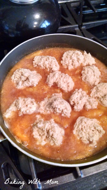 Peach Dumpling dough cooking on top of peaches