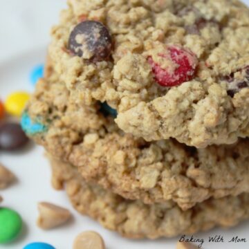 Monster Cookies with peanut butter chips, chocolate chips and M&M's on a flat white surface