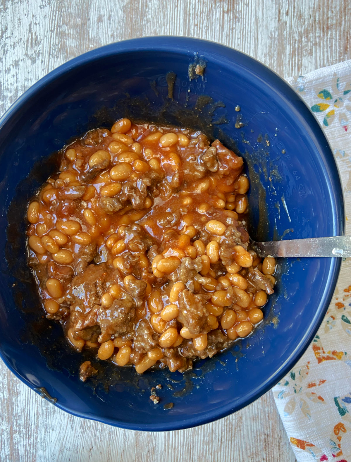 beans and hamburger in a blue bowl. 