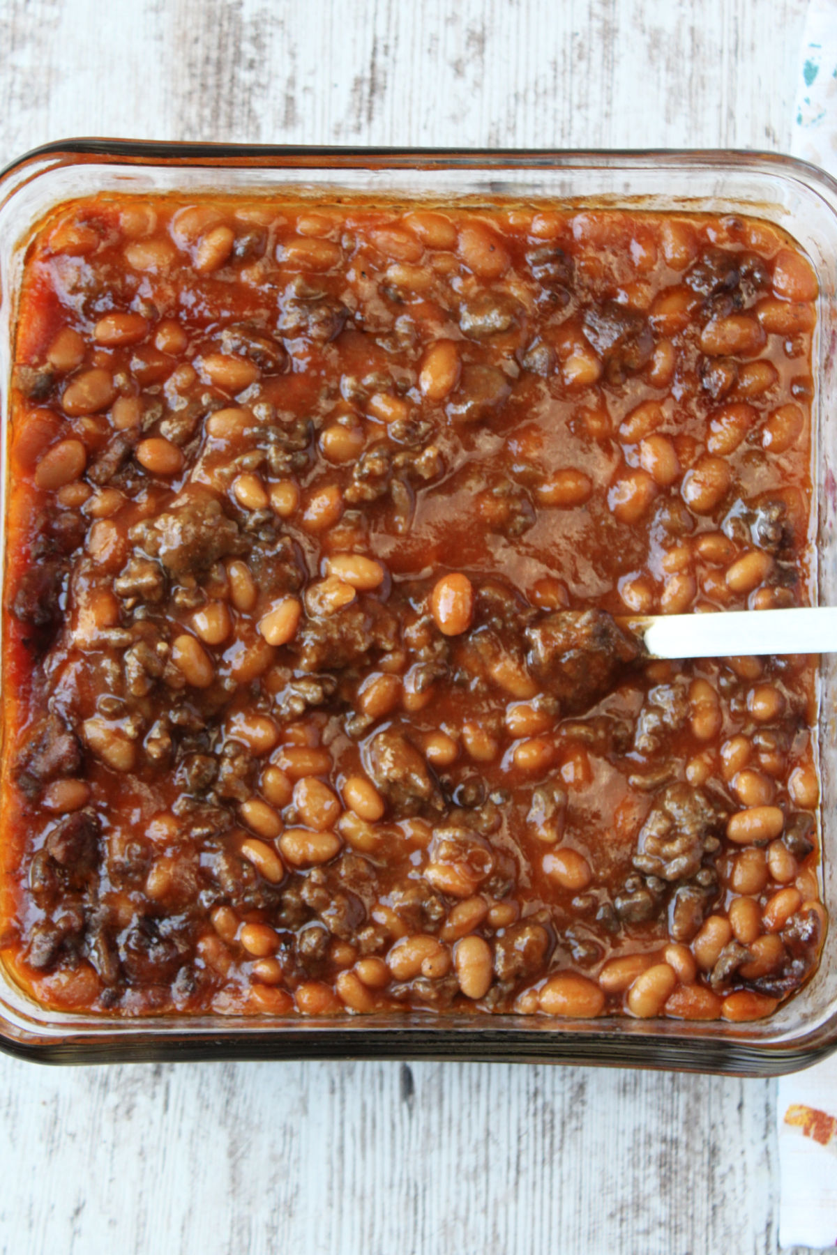 beans and hamburger in a square pan. 