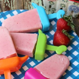 strawberry popsicles on a blue checkered plate