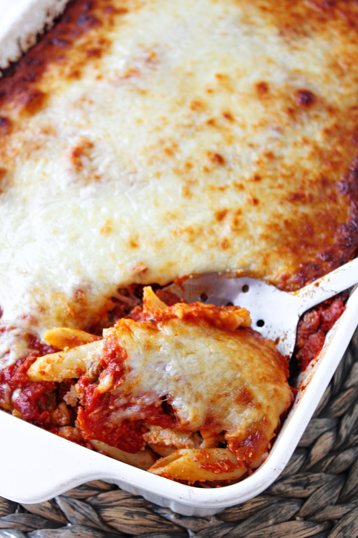 baked mostaccioli casserole with a spoon. 