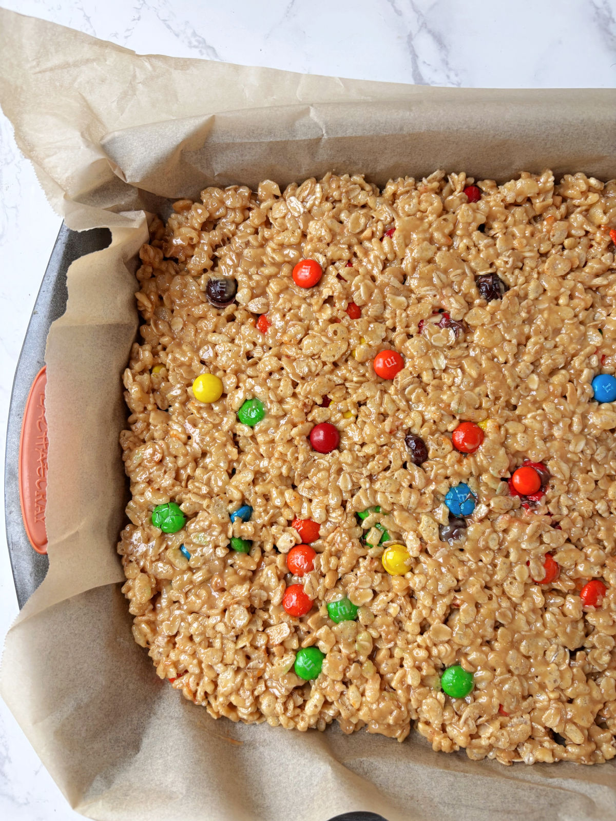 granola bars in a pan with parchment paper.
