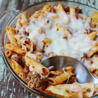 mostaccioli casserole with hamburger and cheese in a dish