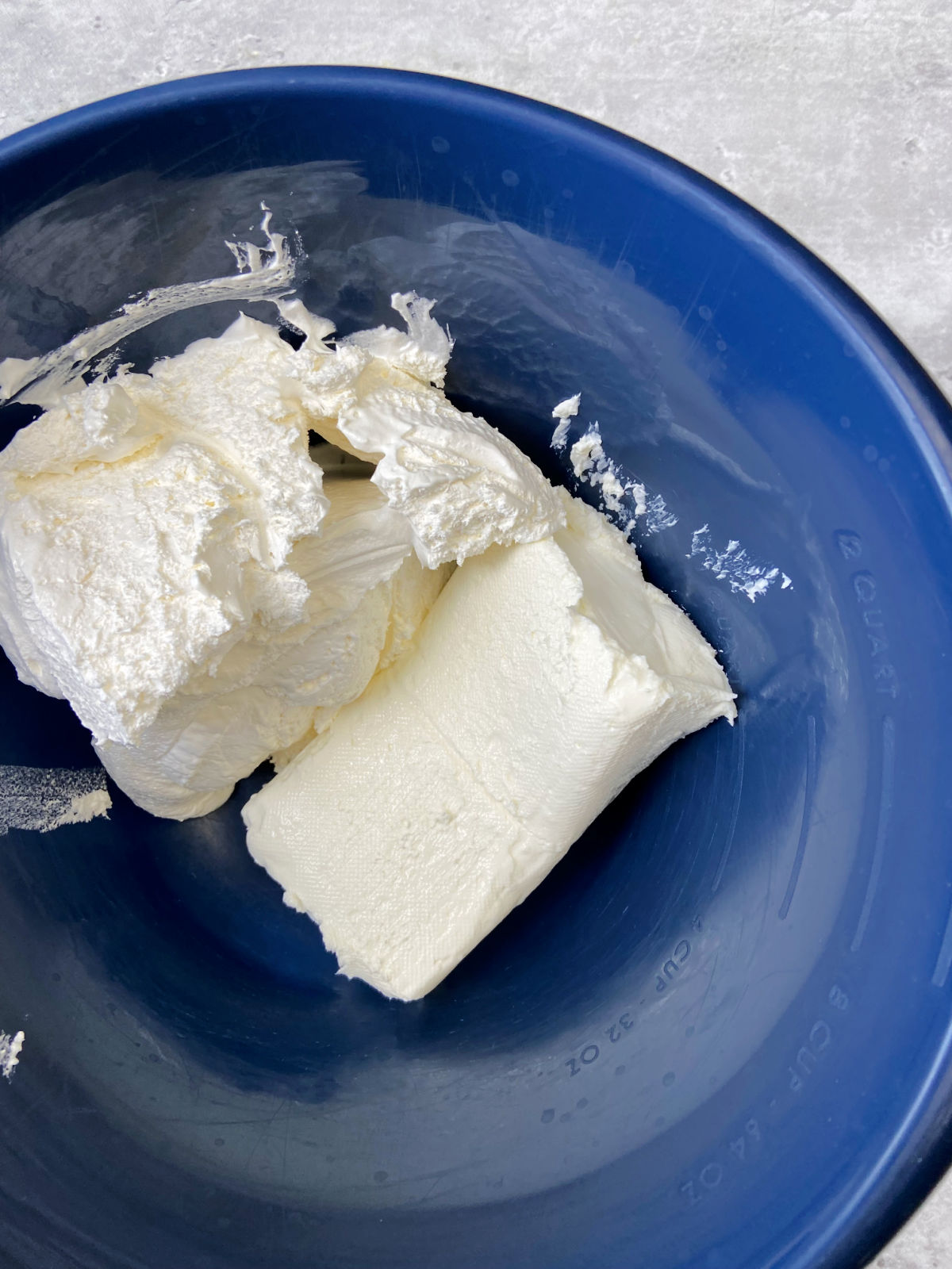 cream cheese and whipped cream in a blue bowl. 