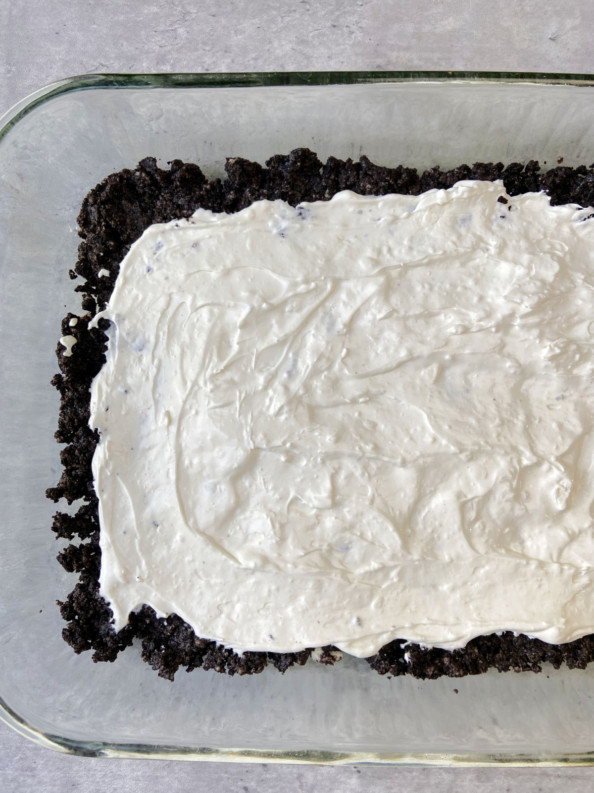 cream cheese mixture in a pan with an Oreo crust. 