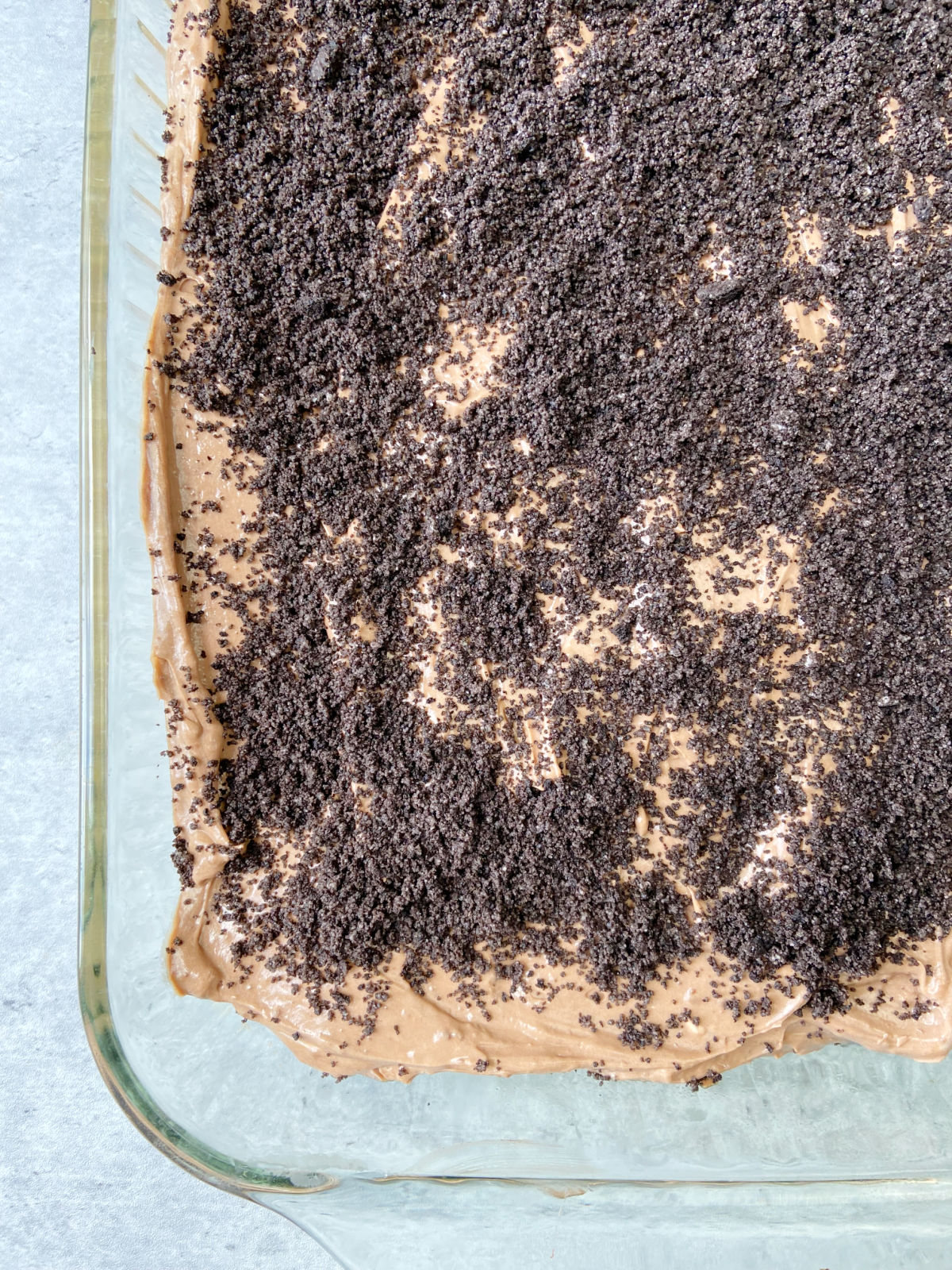 Oreo layer dessert in a baking pan. 