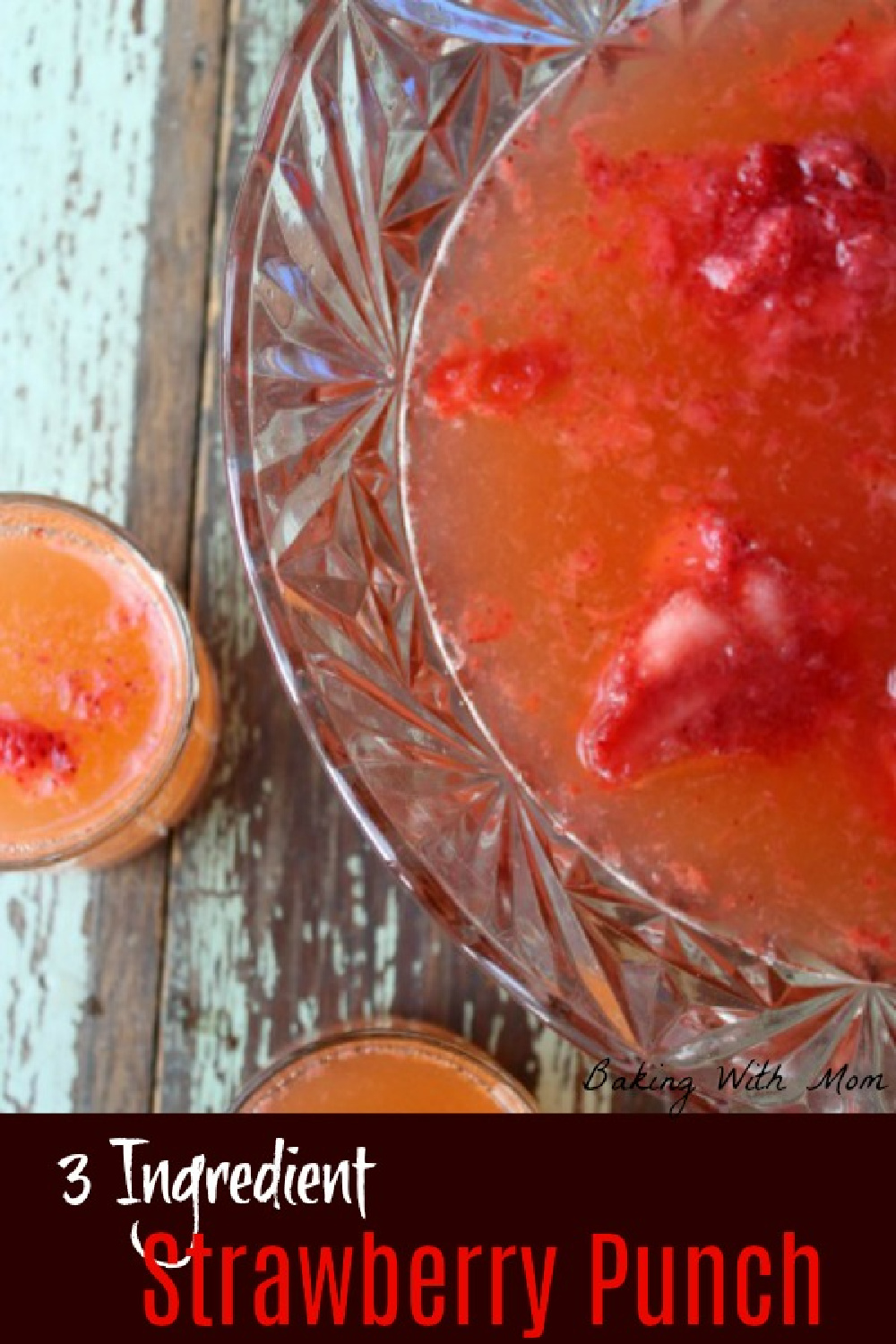 red punch in a punch bowl with strawberries floating. 