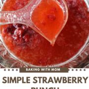 Simple Strawberry Punch in a clear bowl with strawberries.