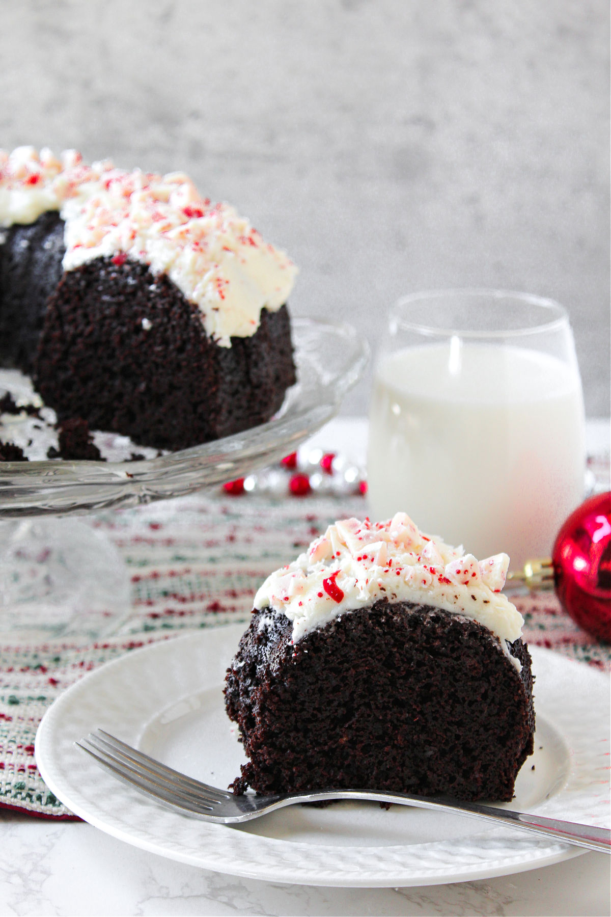 peppermint chocolate cake on a white plate with a fork. 