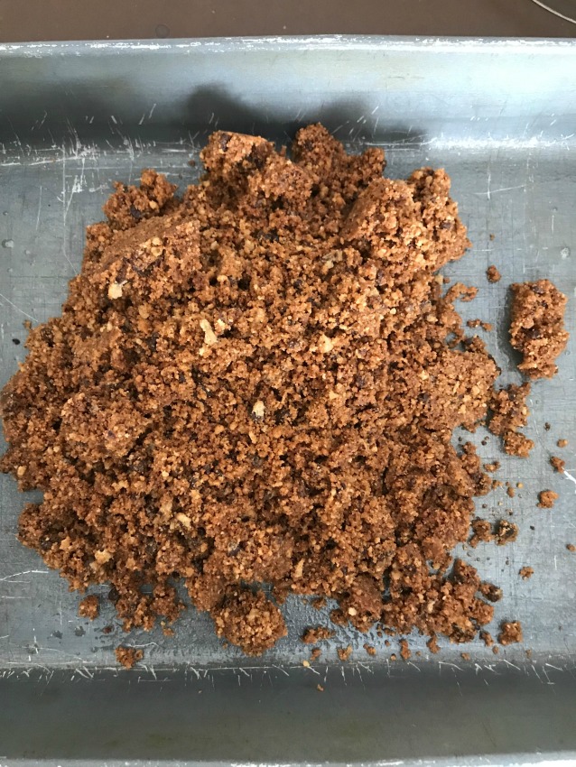 Chocolate chip cookie crumbs in a pan