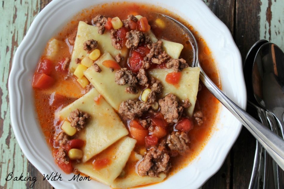 Dumplings with hamburger, tomatoes and corn in a beef broth