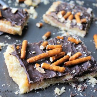 toffee bars on a pan with pretzels on top