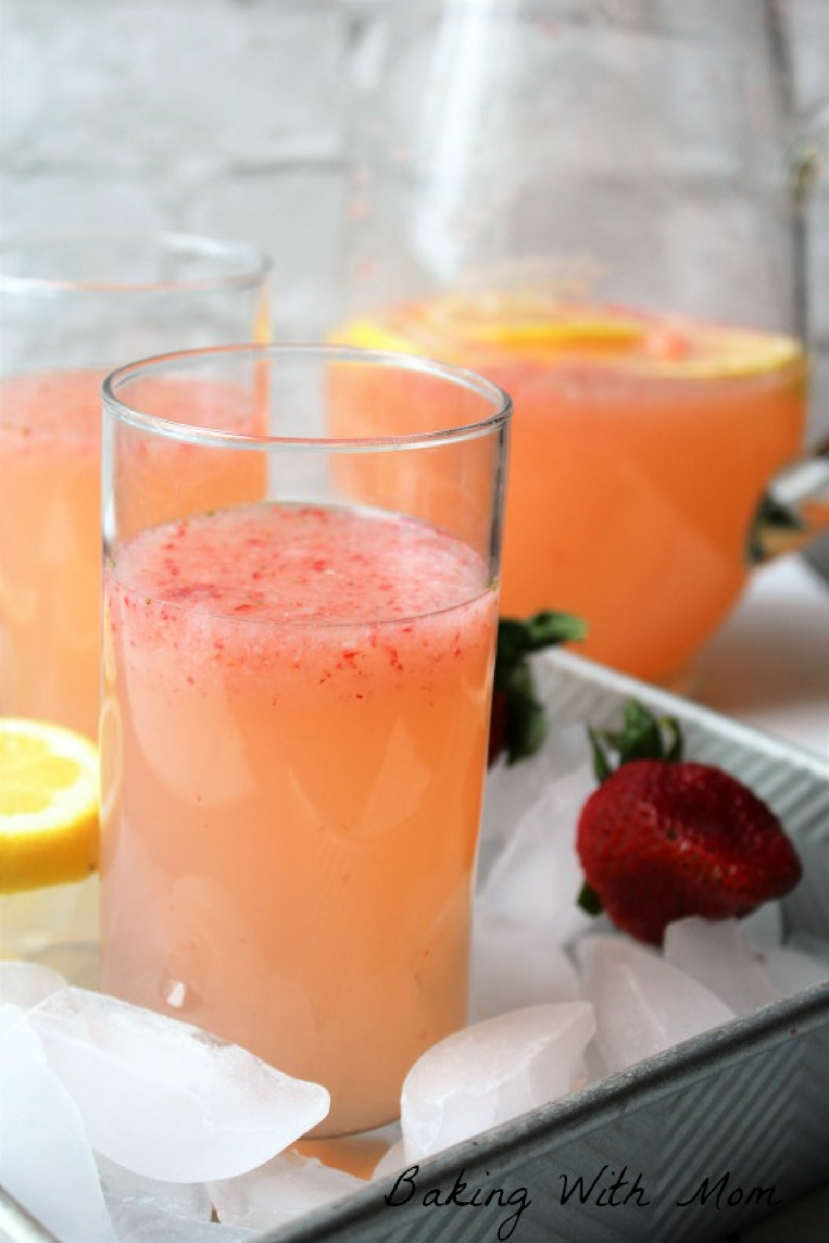 strawberry lemonade with ice and strawberries and lemons. 