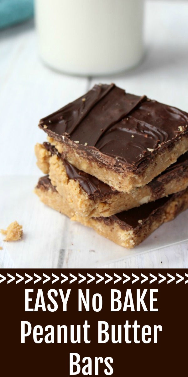 Stack of 3 peanut butter bars on waxed paper with a blue towel and milk behind