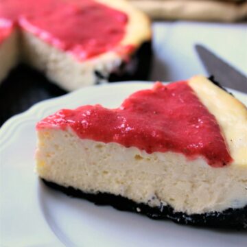 Strawberry Raspberry Cheesecake With OREO Crumb Crust on a white plate