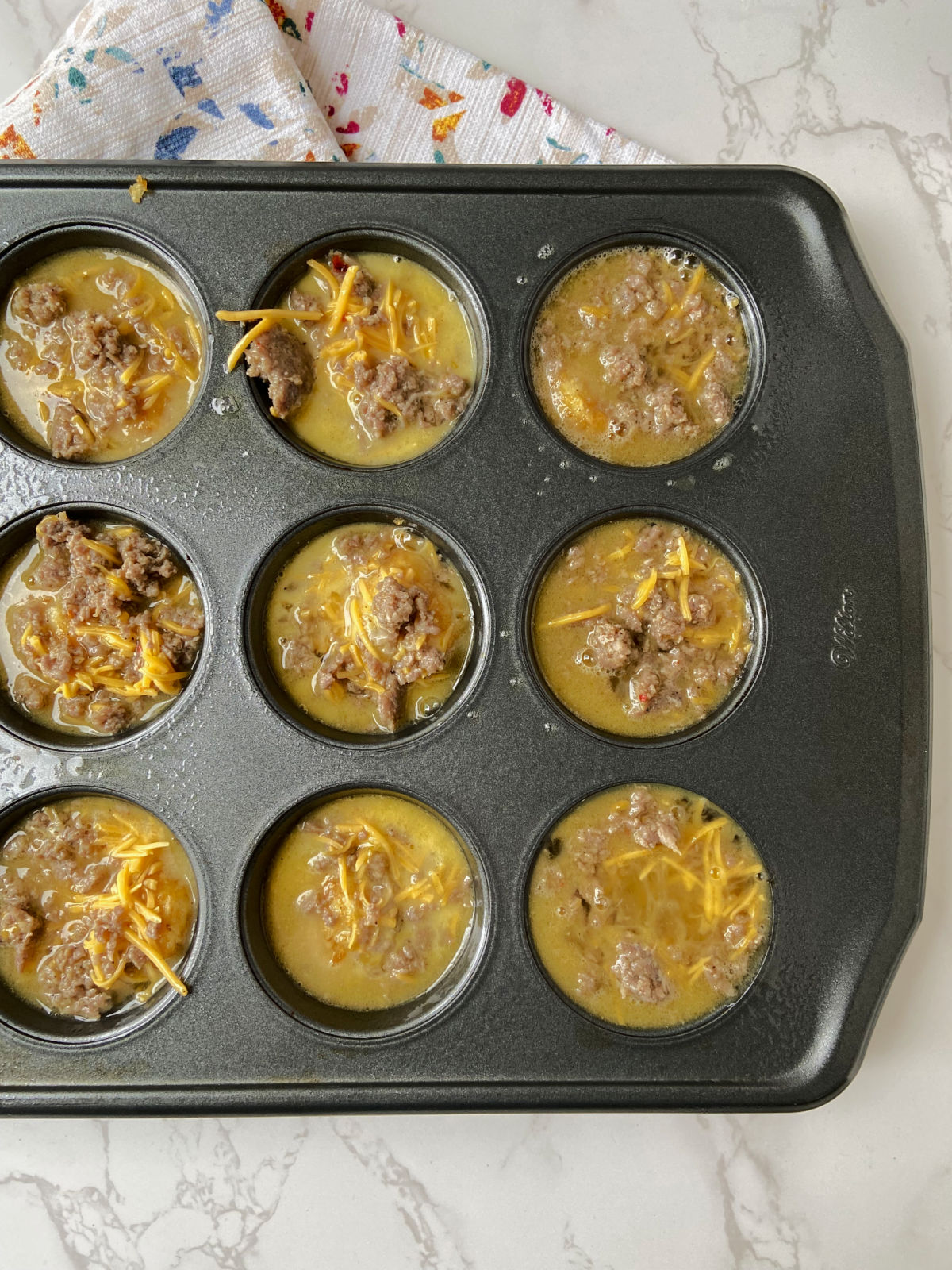 uncooked egg mixture in muffin tins. 