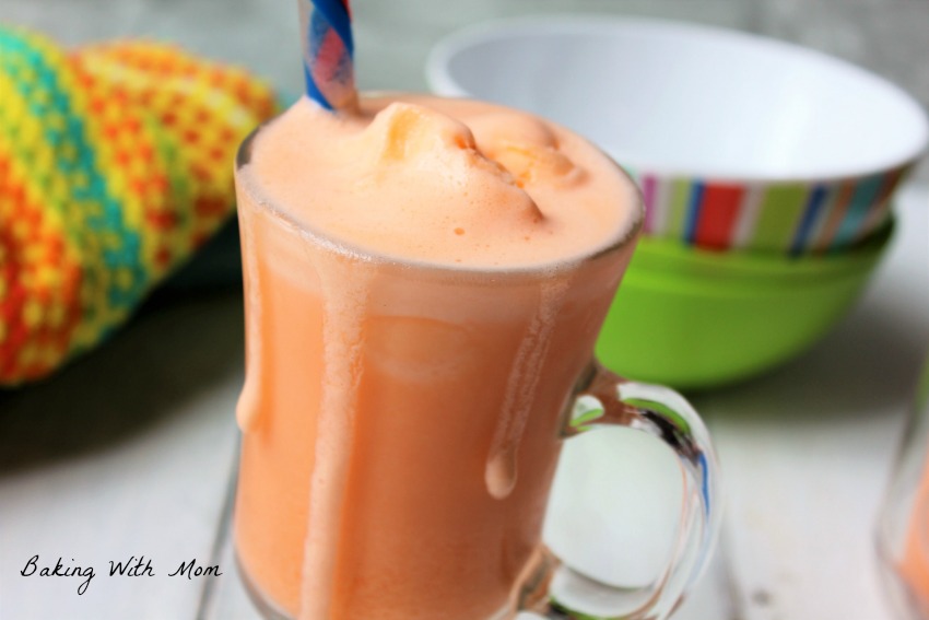 Orange frosty with bowls in the background